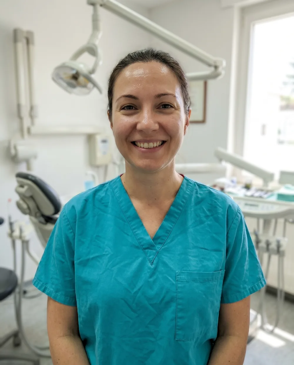 A dental clinician in a bright modern operatory