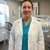 LumiScrubs white clinic lab coat worn over a teal scrub top