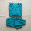 LumiScrubs coordinated teal scrub set, top and matching pant flat-lay