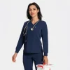 Model wearing the navy long-sleeve underlayer scrub top with a stethoscope