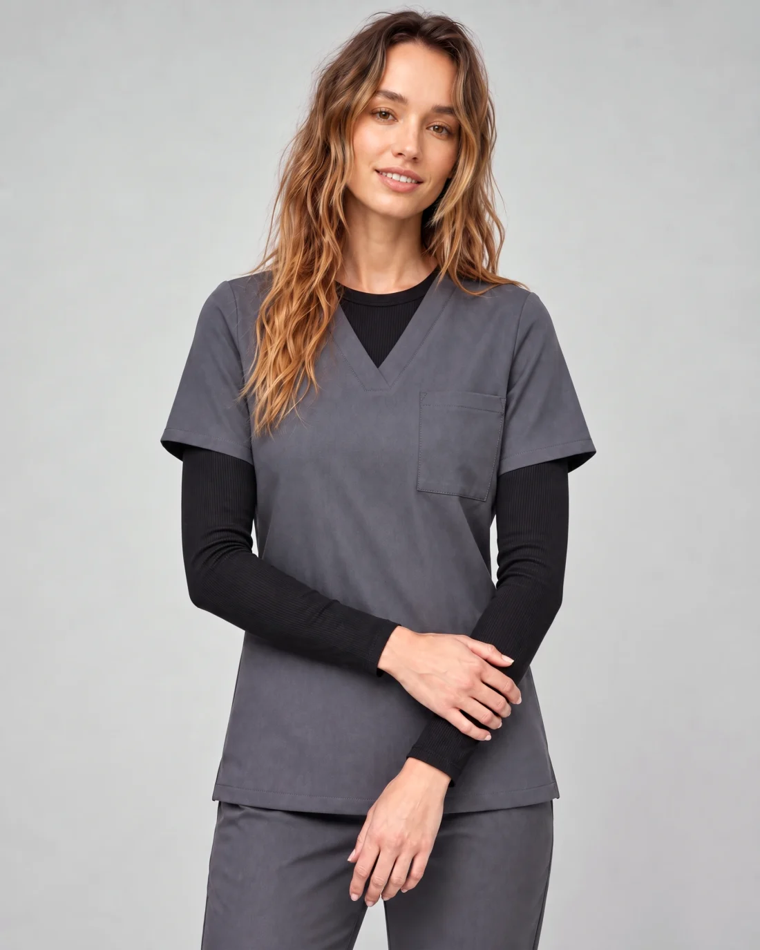 Women's Quick-Dry Long-Sleeve Underscrub shown layered beneath a black scrub top