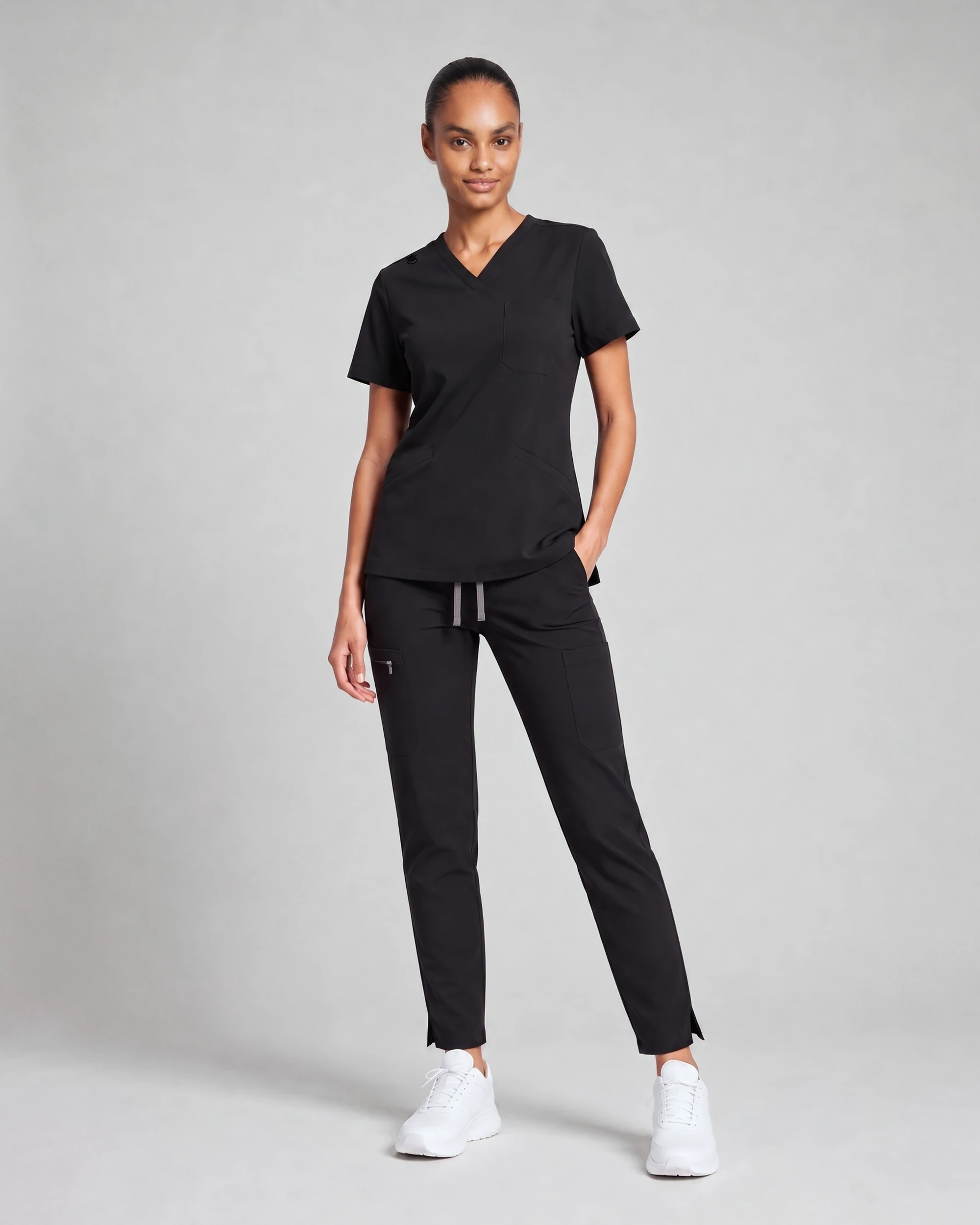 Women's Core Scrub Set in Black, front view showing the V-neck top and straight-leg pant