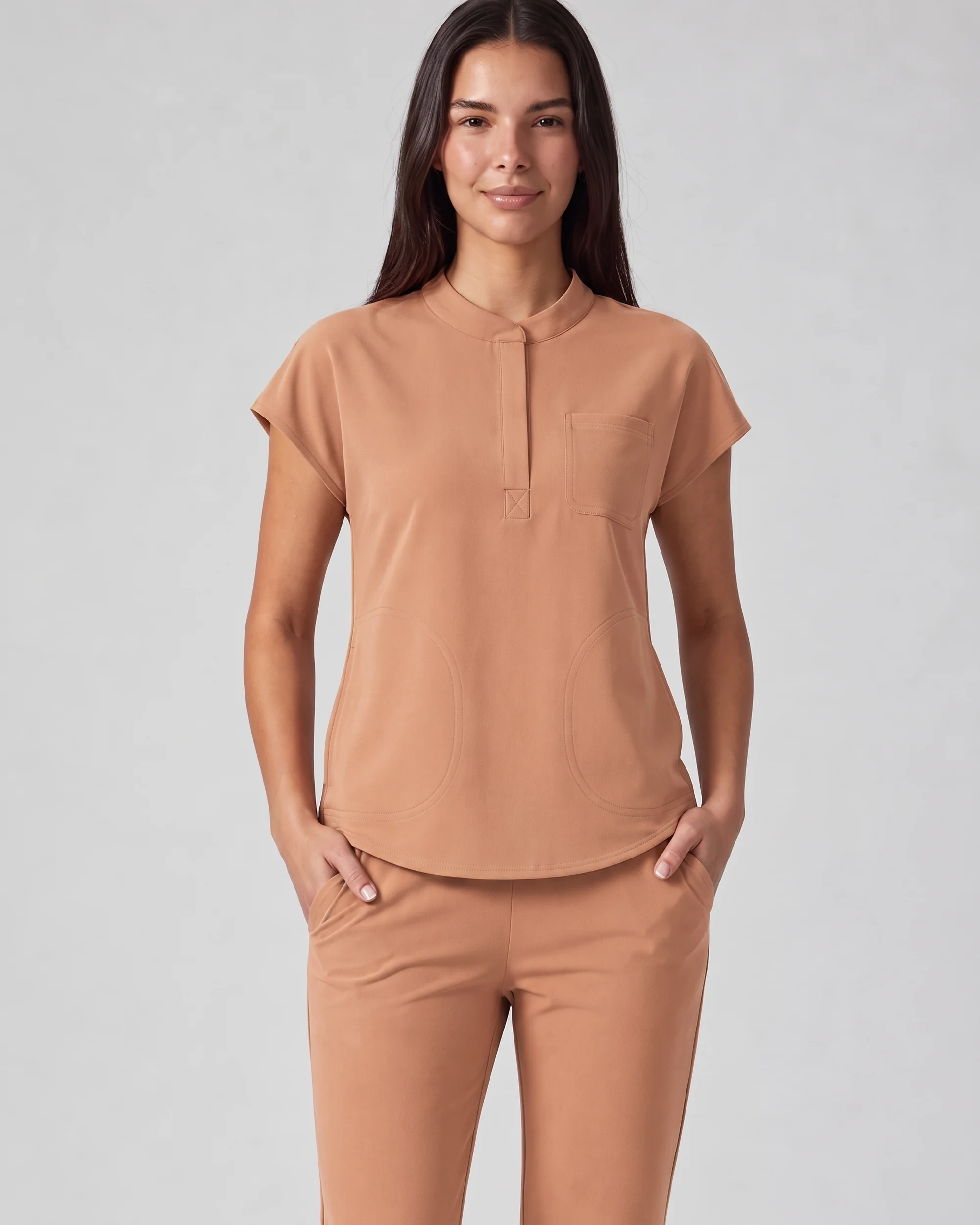 Front Desk Collar Top in Caramel, front studio view showing the collar, covered placket, short sleeves, chest pocket, and lower front pockets