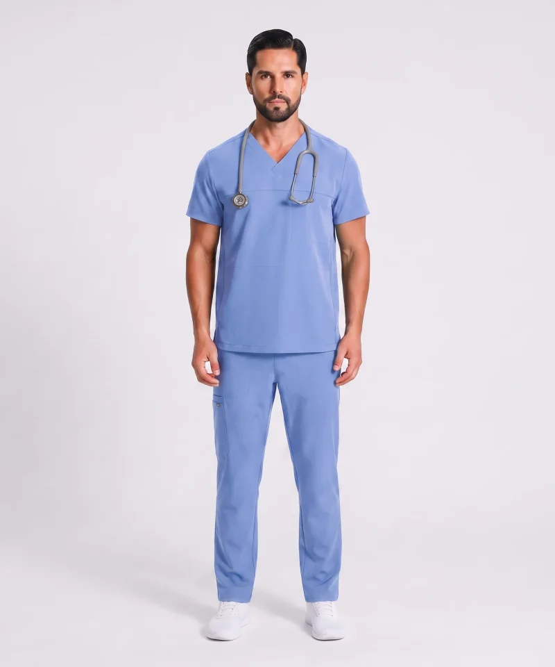 Man wearing the Lumi Motion scrub set in Ceil Blue, full-figure front view