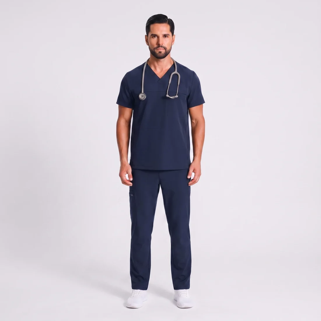 Man wearing the Lumi Motion scrub set in Navy, full-figure front view