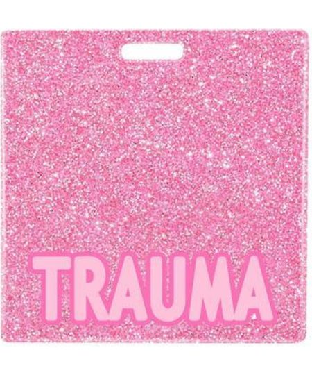 TRAUMA badge buddy card in pink glitter with badge reel