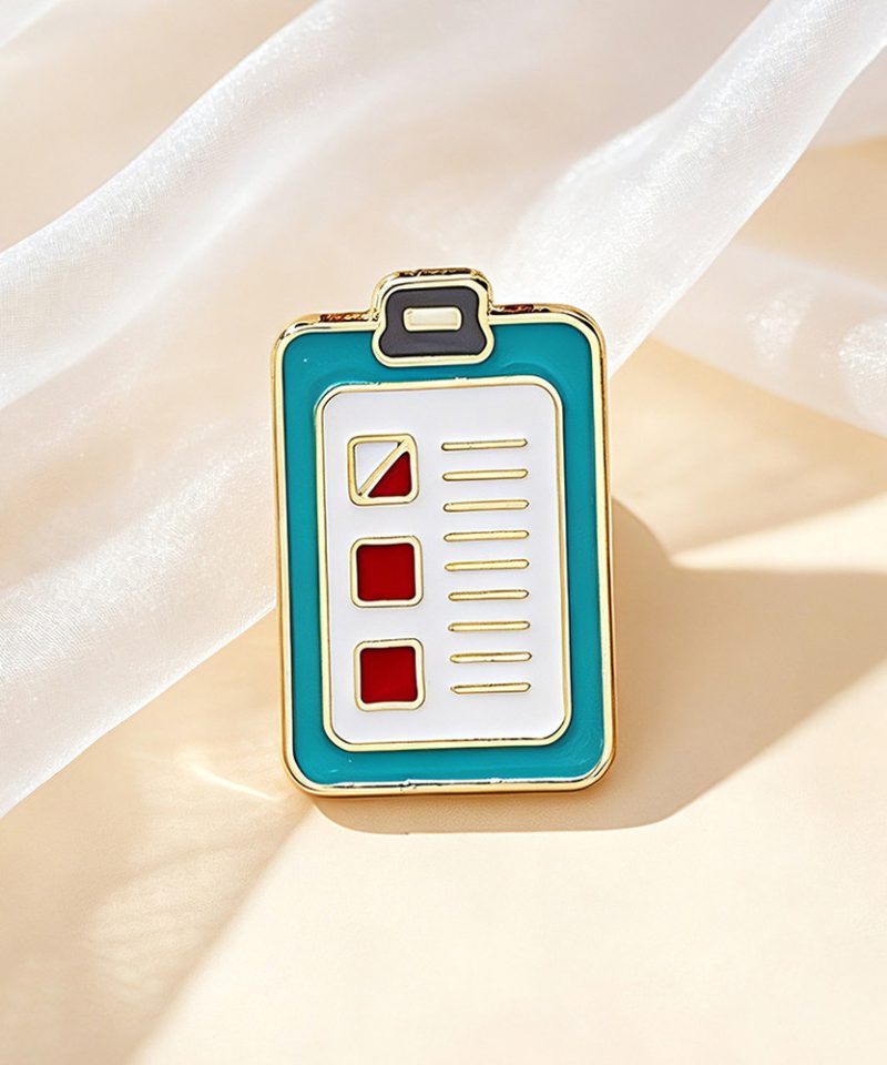 Teal clipboard chart enamel pin with a checklist face