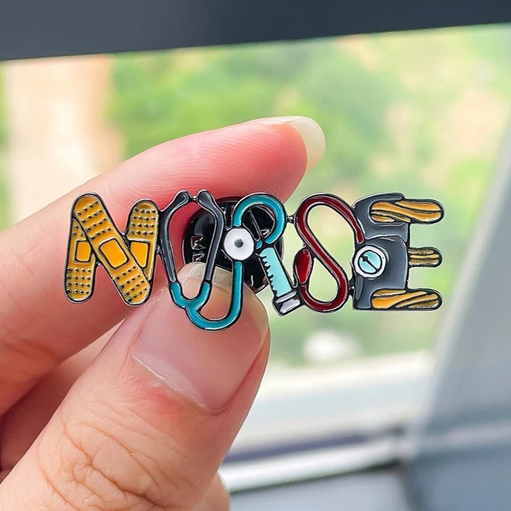 NURSE enamel pin held between two fingers