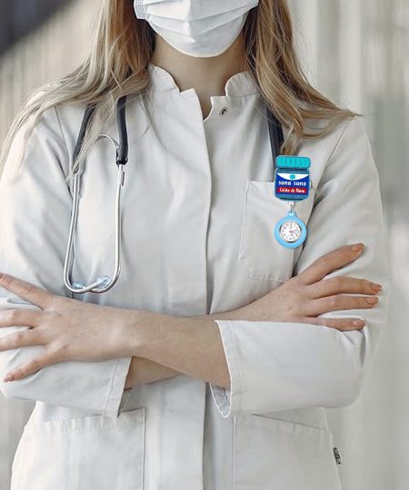 Fob watch clipped to a lab coat pocket